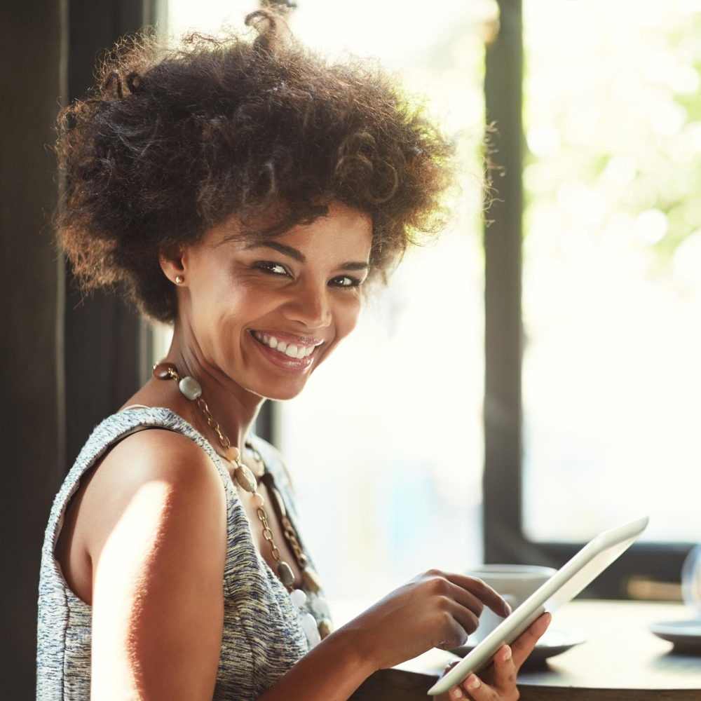 Woman using a tablet in a bright workspace