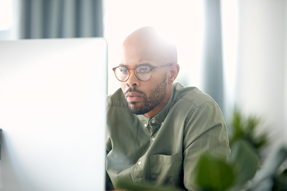 Technology professional working at a desktop computer
